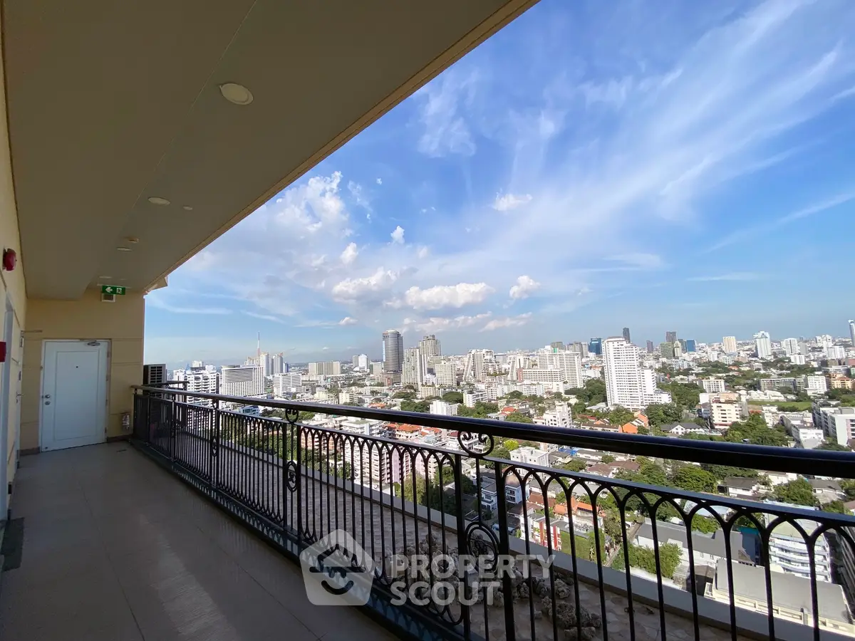 Stunning cityscape view from a spacious balcony in a high-rise building.