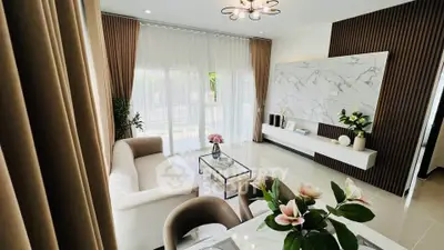 Elegant living room with modern decor, large windows, and stylish furniture in a bright, airy space.
