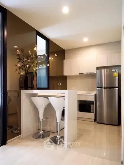 Modern kitchen with sleek appliances and stylish bar stools