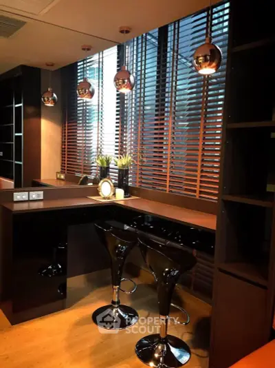 Modern kitchen with sleek black bar stools and stylish pendant lighting