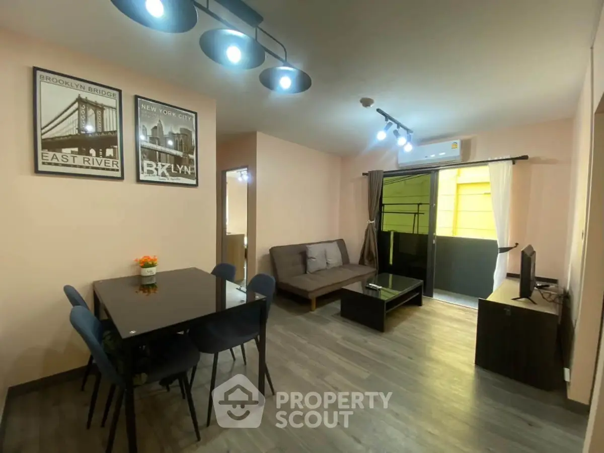 Modern living room with stylish decor and balcony access in a cozy apartment.