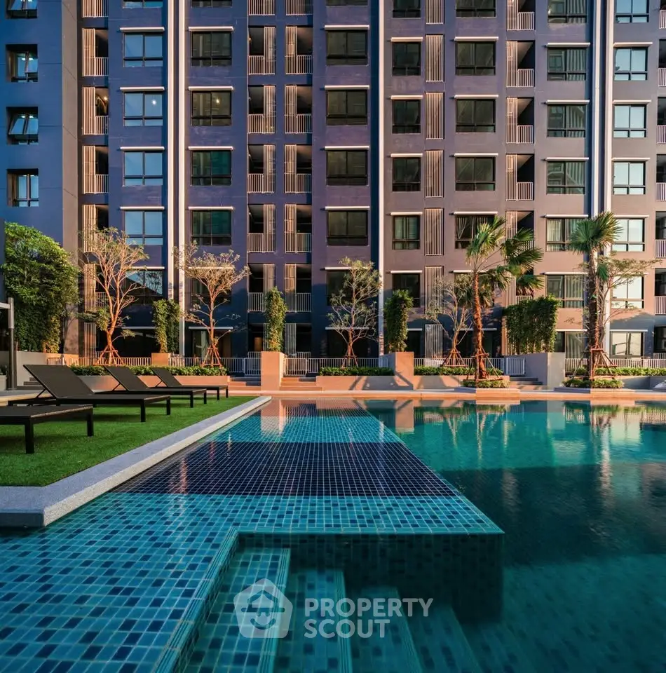 Luxurious apartment building with stunning pool and modern design, perfect for urban living.