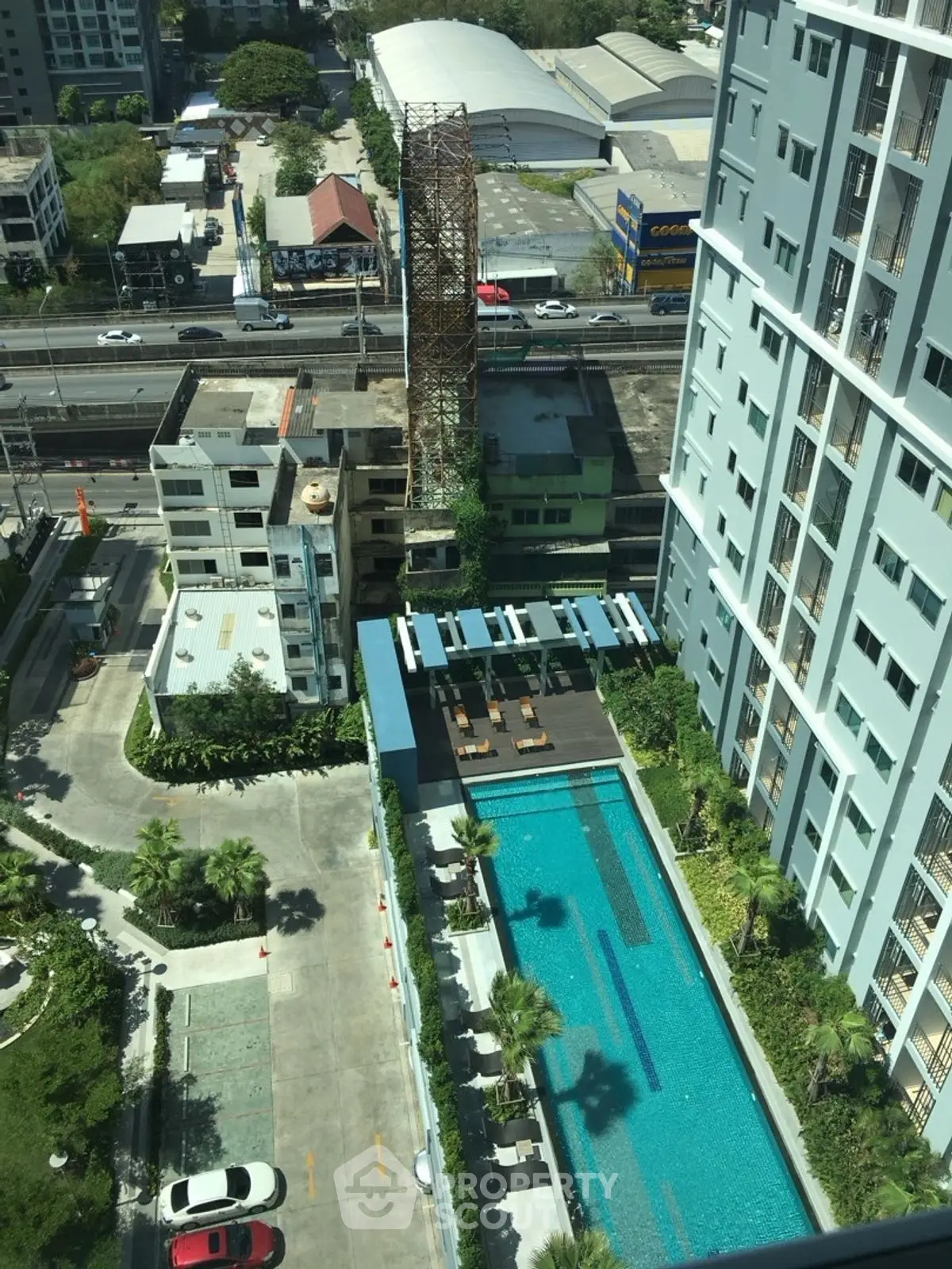 Stunning aerial view of modern apartment complex with pool and cityscape