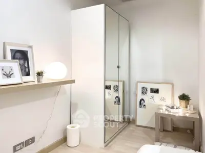 Modern bedroom with sleek mirrored wardrobe and minimalist decor