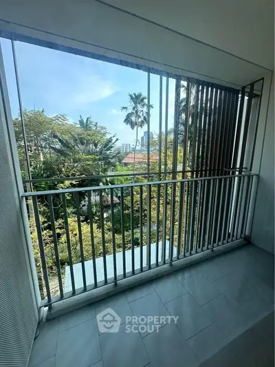 Spacious balcony with lush garden view and modern railing design.