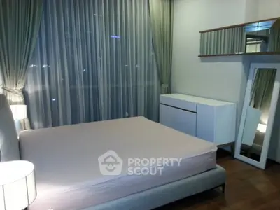 Modern bedroom with large windows and stylish decor