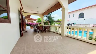 Spacious outdoor patio with pool view, perfect for relaxation and entertaining.