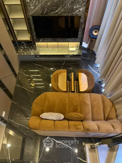 Luxurious living room with marble flooring and plush brown sofa