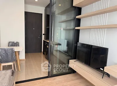 Modern apartment interior with open layout, featuring a sleek kitchen and cozy living area.