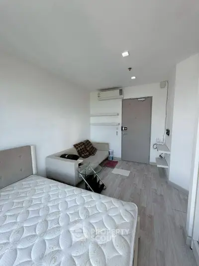 Modern minimalist bedroom with cozy sofa and stylish decor