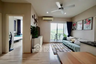 Spacious living room with modern decor and balcony view in a stylish apartment.