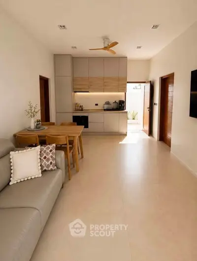 Modern open-plan living room with sleek kitchen and stylish decor