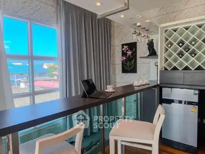 Modern kitchen with stylish bar counter and wine rack, featuring large windows and elegant decor.