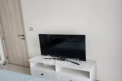 Modern bedroom with sleek TV setup and minimalist decor