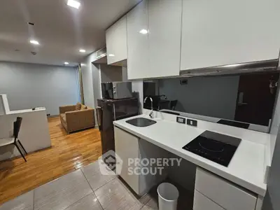 Modern open-layout kitchen with sleek appliances and cozy living area