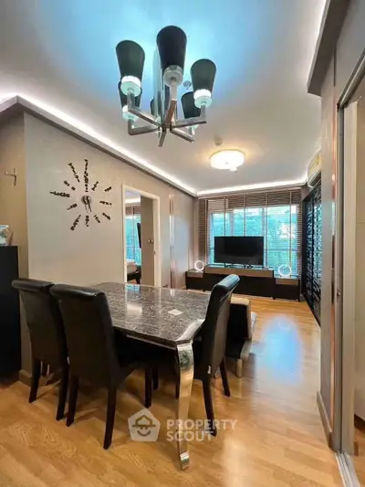 Modern living room with elegant dining area and stylish lighting