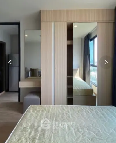 Modern bedroom with large window and stylish wardrobe