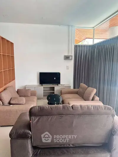 Modern living room with cozy seating and natural light