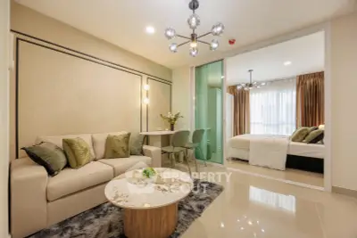 Modern living room with elegant decor and view into cozy bedroom
