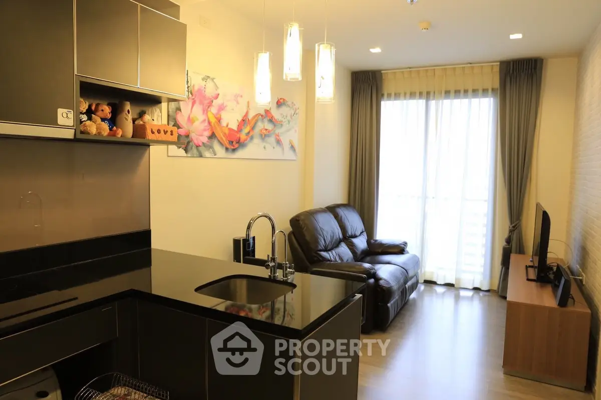 Modern living room with sleek kitchen, cozy seating, and large window for natural light.