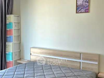 Modern bedroom with stylish headboard and colorful storage boxes, perfect for urban living.