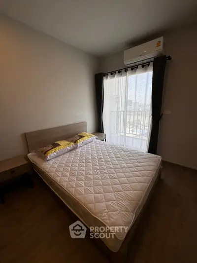 Cozy bedroom with balcony view and air conditioning in modern apartment