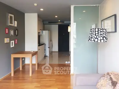 Modern living room with wooden flooring and stylish decor in a contemporary apartment.