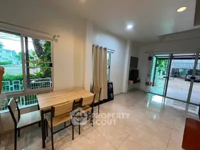 Spacious dining area with large windows and garden view in modern home
