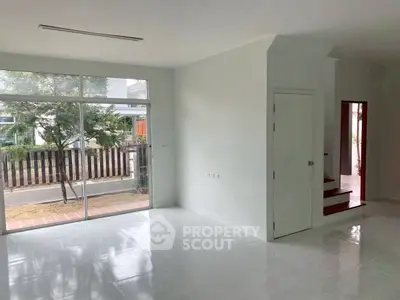 Spacious modern living room with large windows and garden view