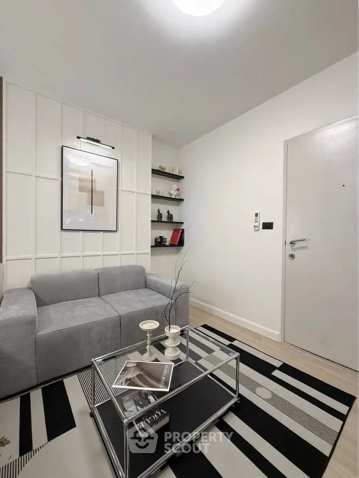 Modern living room with stylish decor and cozy gray sofa in a chic apartment.