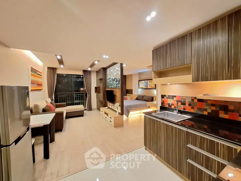 Modern open-plan living room and kitchen with stylish decor and cozy ambiance.