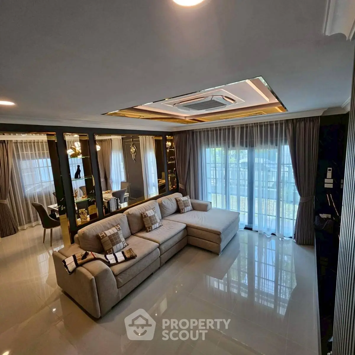 Luxurious living room with elegant decor and large windows offering natural light.