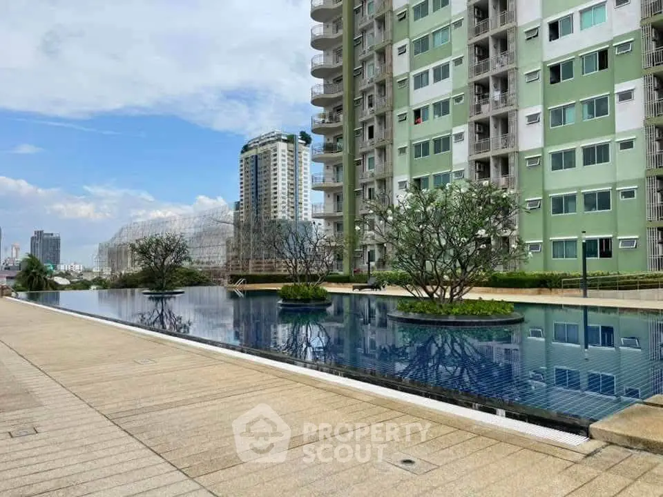 Luxurious apartment complex with stunning pool and city views, perfect for modern urban living.