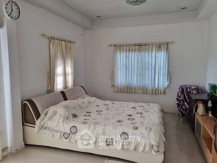 Spacious bedroom with elegant decor and natural light