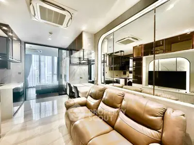 Luxurious modern living room with leather sofa and mirrored wall in high-end apartment