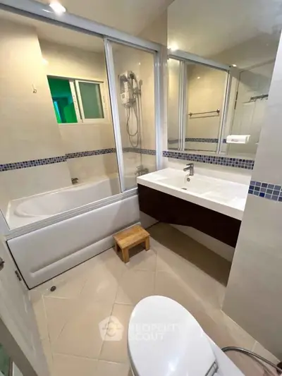 Modern bathroom with bathtub and sleek fixtures in a contemporary apartment.
