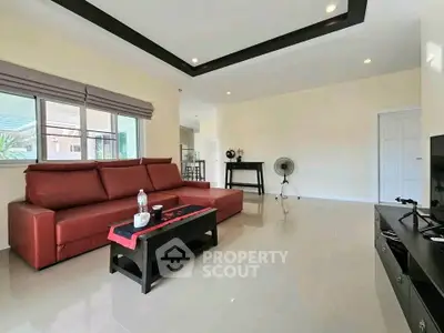 Spacious modern living room with red sofa and sleek decor
