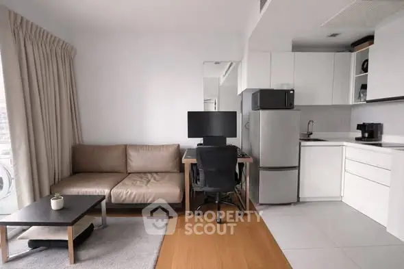Modern studio apartment with sleek kitchen and cozy living area, perfect for urban living.