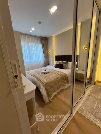 Cozy modern bedroom with mirrored closet and elegant lighting