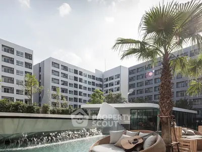 Luxurious apartment complex with poolside seating and lush palm trees, offering a serene urban oasis.