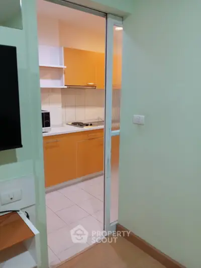 Modern kitchen with vibrant orange cabinets and sleek design