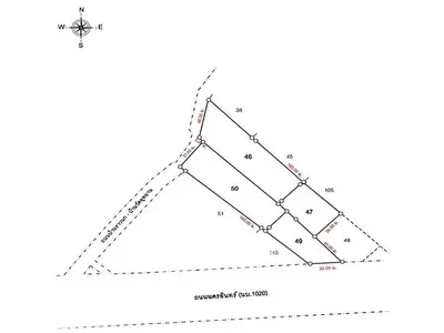 Detailed real estate plot map with compass and plot numbers for precise land assessment.