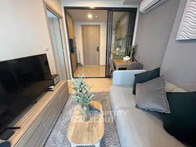 Modern living room with stylish decor and open layout, featuring a cozy sofa and sleek TV unit.