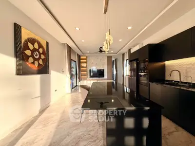 Luxurious modern kitchen with sleek black countertops and open layout, perfect for entertaining.