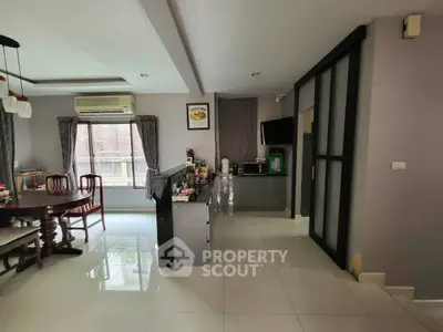 Spacious living room with modern decor and large windows