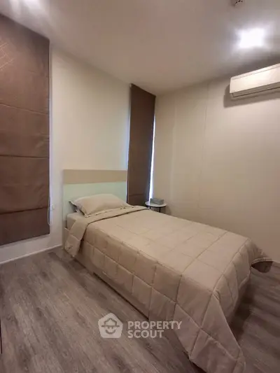 Cozy minimalist bedroom with single bed and air conditioning