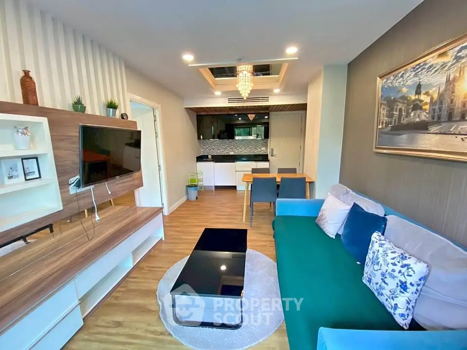 Modern living room with stylish decor and open kitchen layout in a cozy apartment.