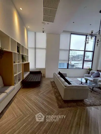 Spacious modern living room with large windows and stylish furniture