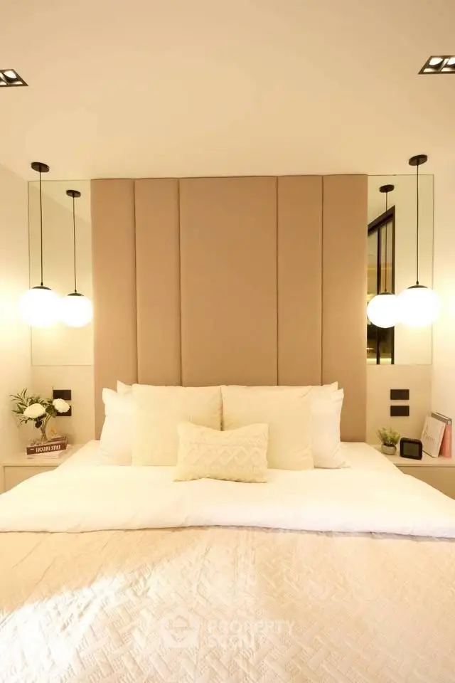 Luxurious bedroom with elegant lighting and plush bedding, perfect for relaxation and comfort.