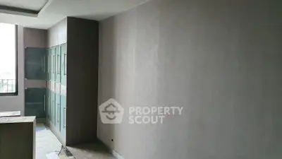 Modern kitchen with sleek cabinetry and large window offering natural light